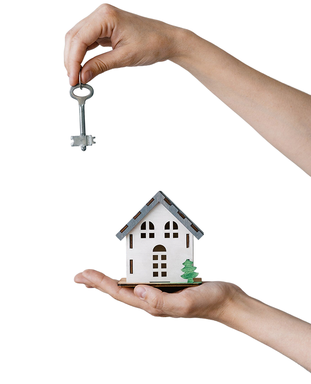 Hand holding a house key above a model home