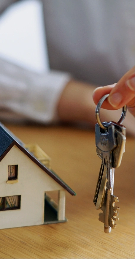 Hand holding house keys